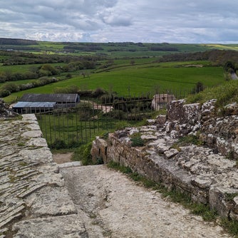 Photograph showing ruins of sallyport entrance to Corfe Castle near the West Bailey with Purbeck hills in the background